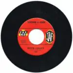 A black and red record with the words " louder & louder " on it.