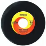 A black and yellow record with the word " enamorado " on it.