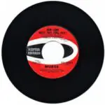 A black and white record with red labels