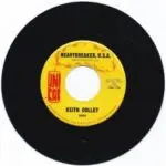 A yellow and black record with the words " heartbreaker, u. S. A." on it