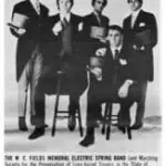 A group of men in suits and ties sitting on chairs.