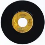 A black and gold record with the words " jag " on it.