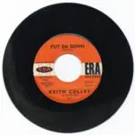 A black and white record with an orange label